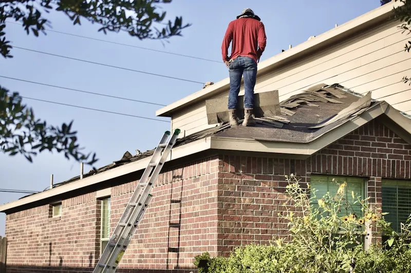 Professional roofer working on a residential roof in Defiance